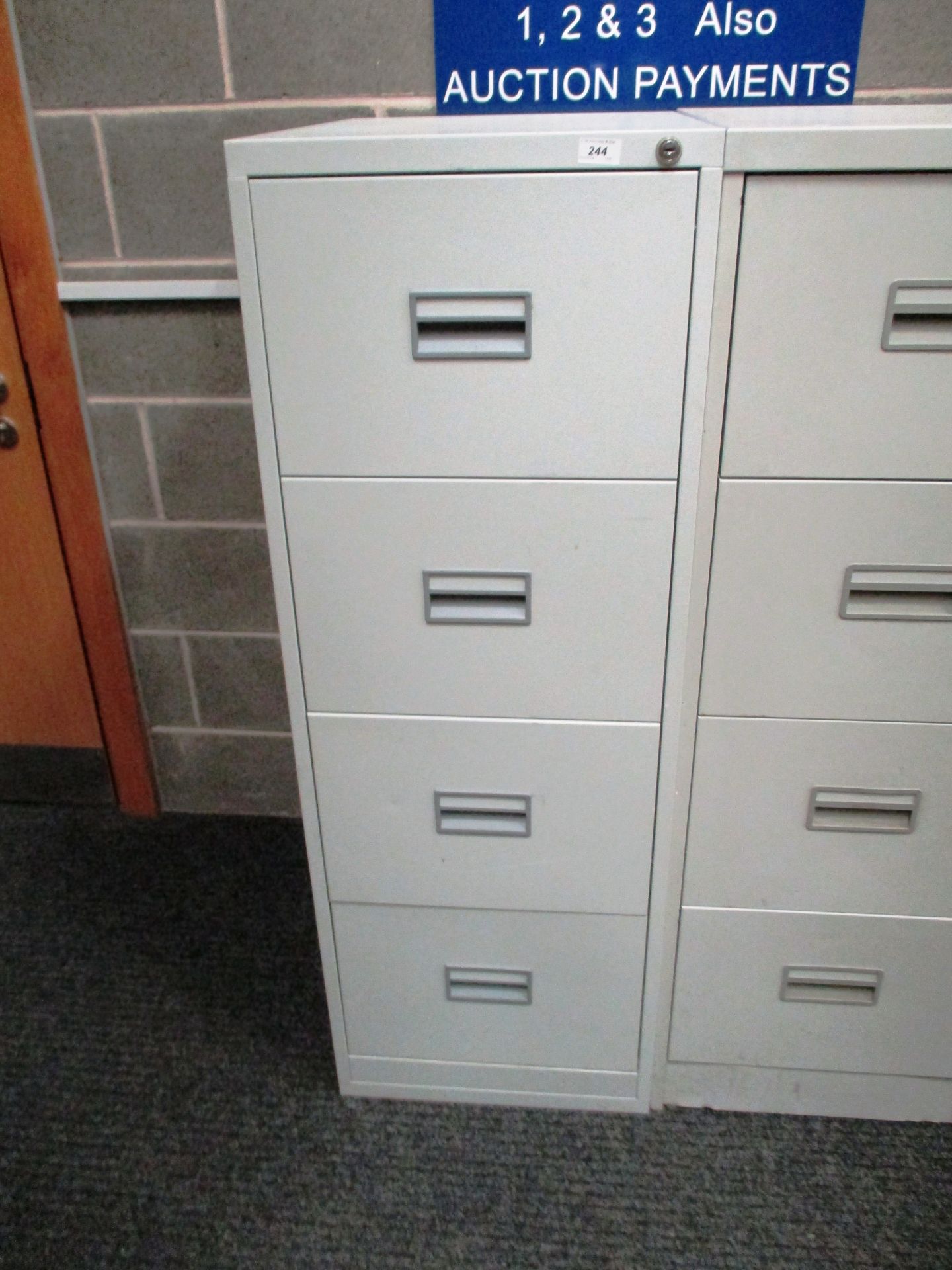 A grey metal four drawer filing cabinet (unlocked no key)