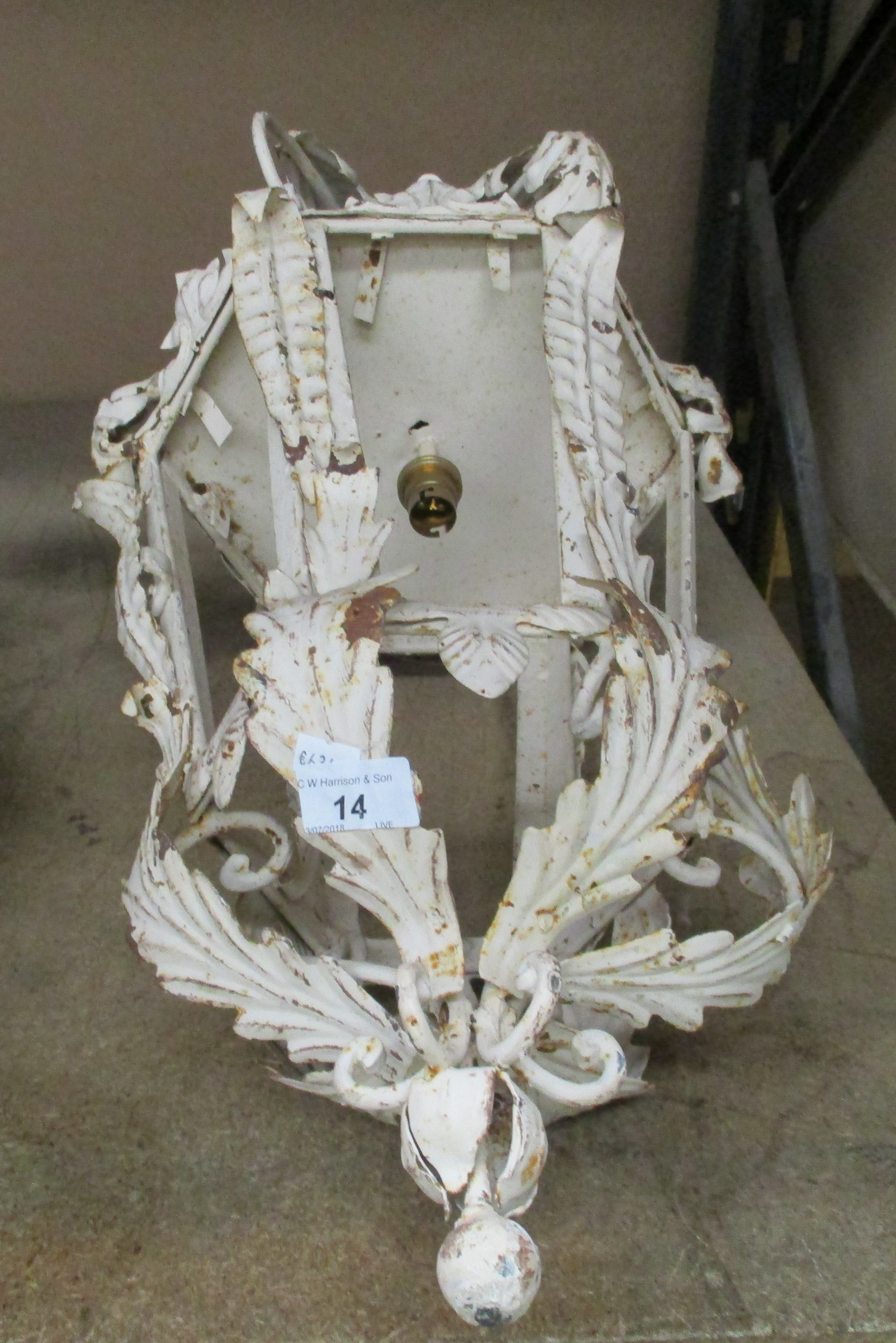 A French style distressed metal wall light with arm bracket