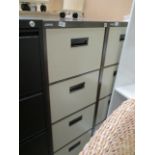 A Staples brown and beige metal four drawer filing cabinet (unlocked no keys)