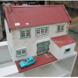 A white and brown painted dolls house 62 x 46 x 52cm high complete with a metal toy car