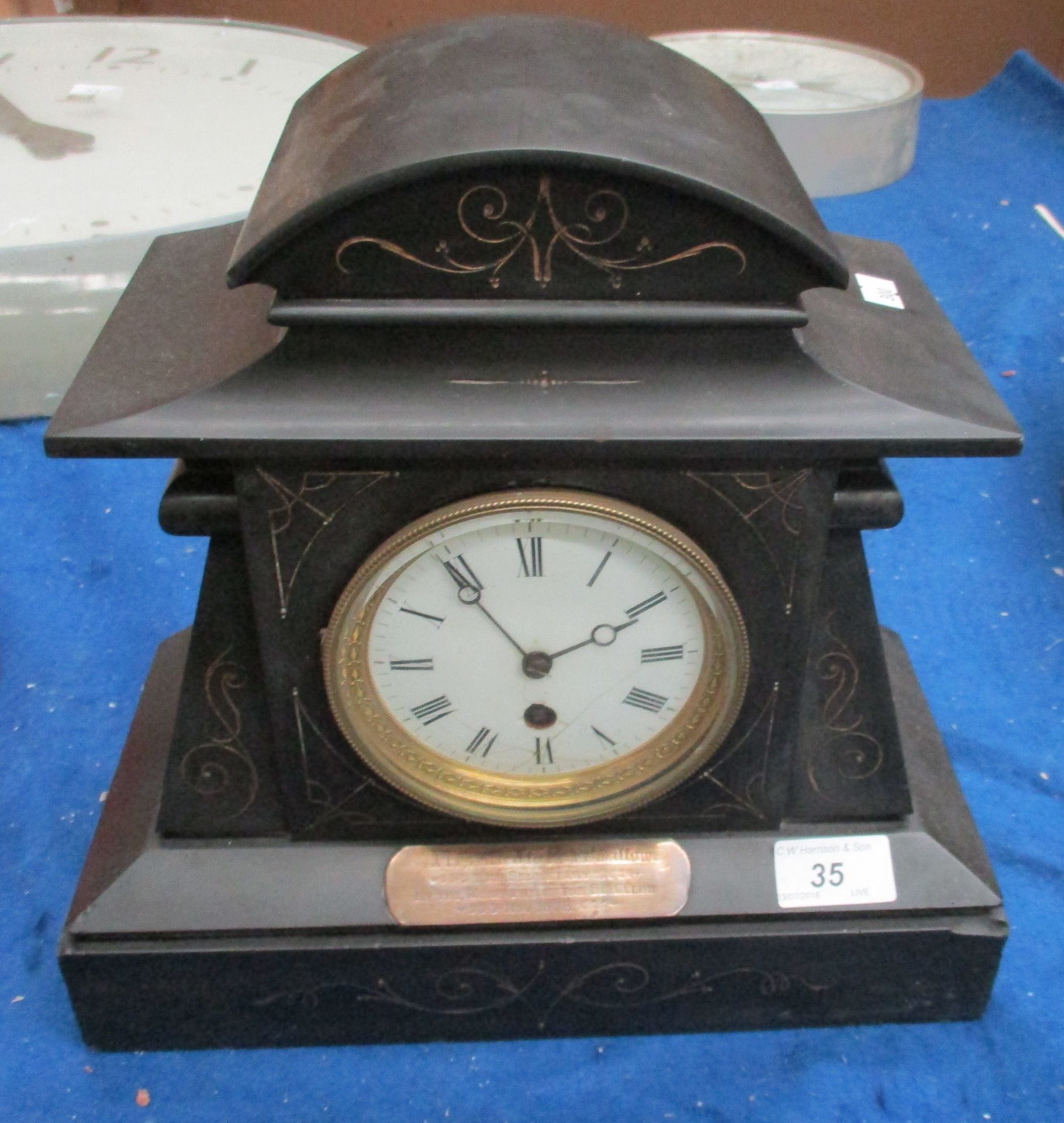 A Victorian black marble mantel clock