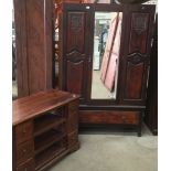A mahogany wardrobe with centre mirror door and under drawer,
