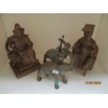 Four items - two brass elephants and two Oriental wooden statues