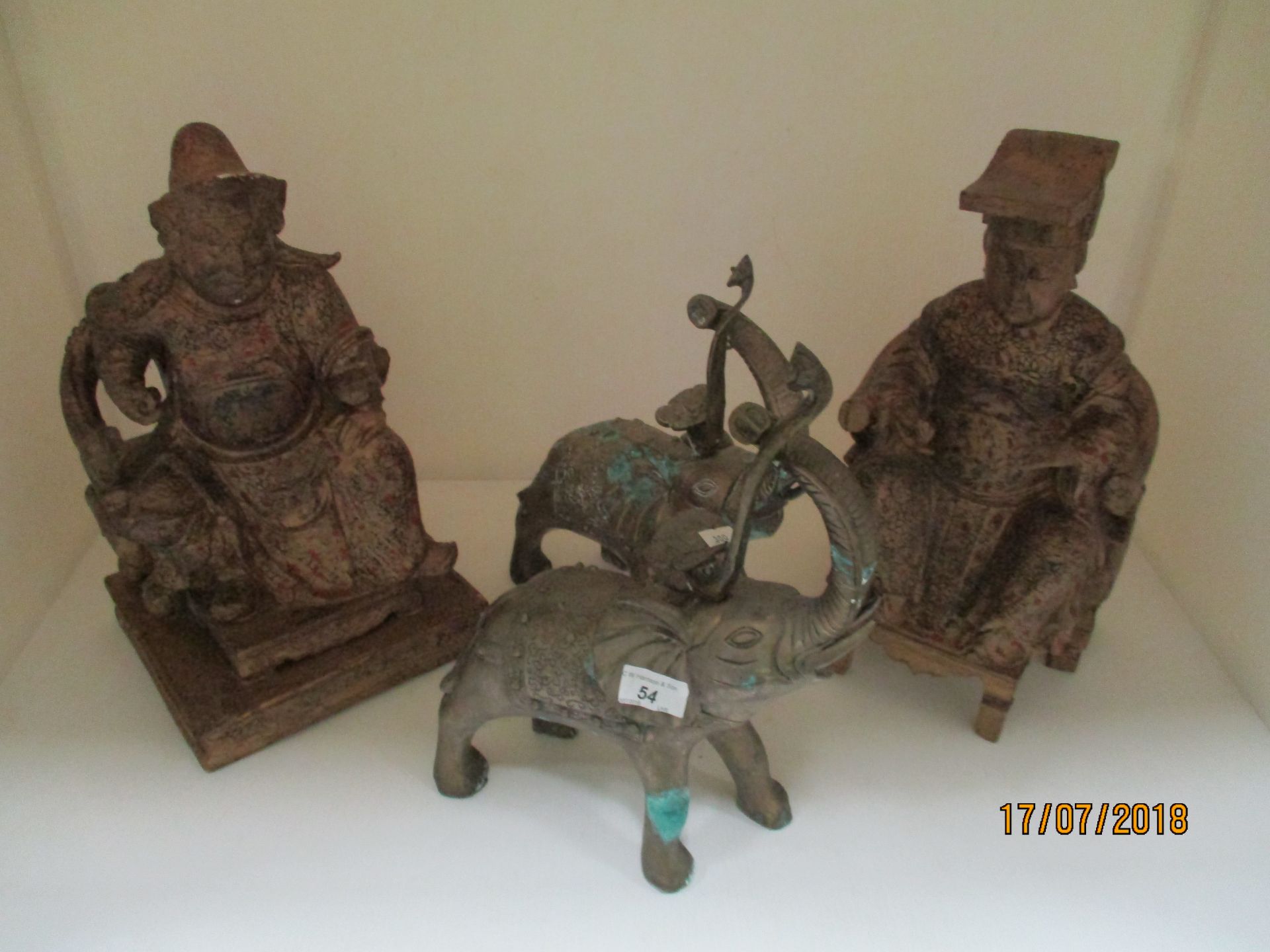 Four items - two brass elephants and two Oriental wooden statues