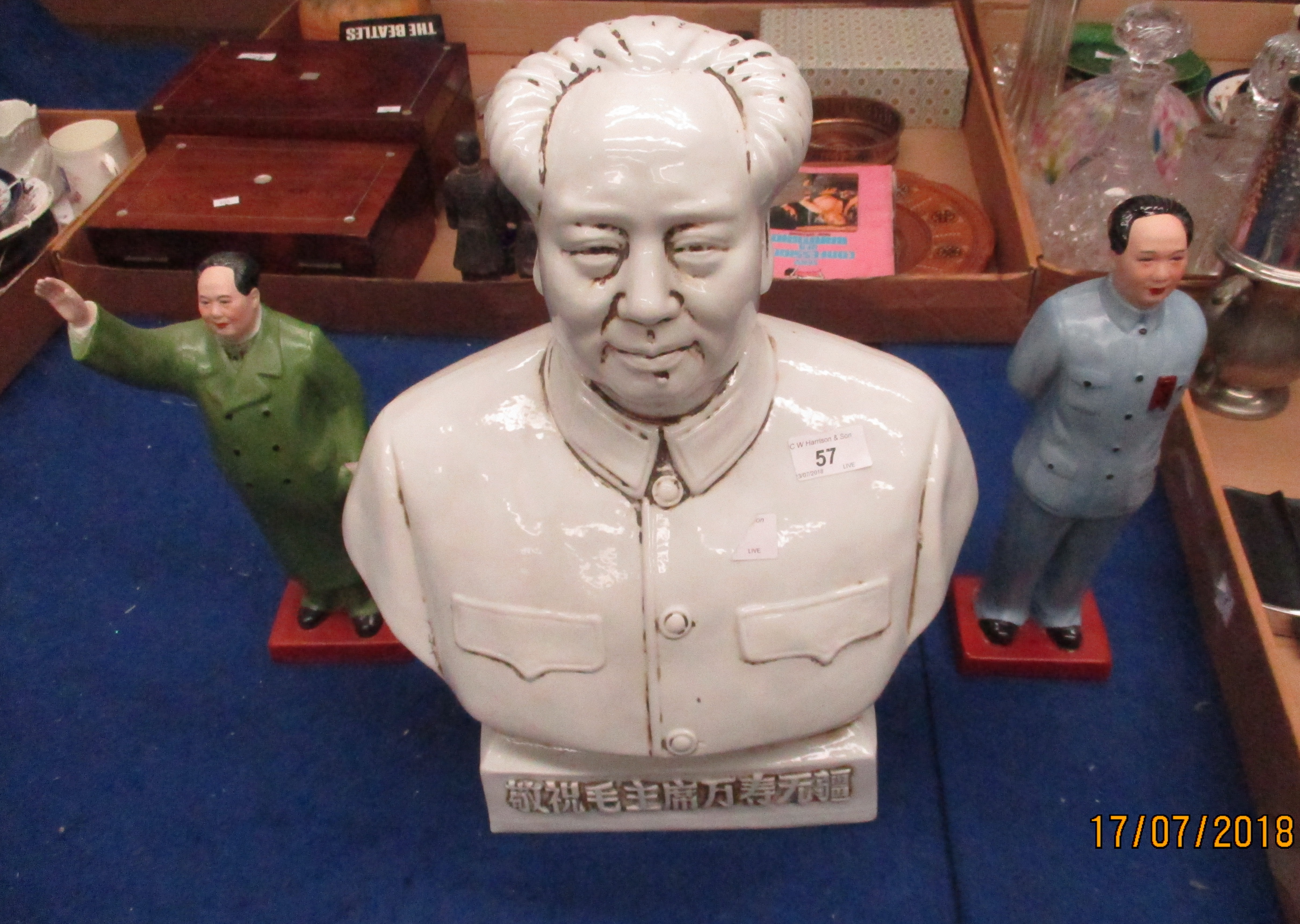 A ceramic bust of Chairman Mao and two pottery Chairman Mao figurines