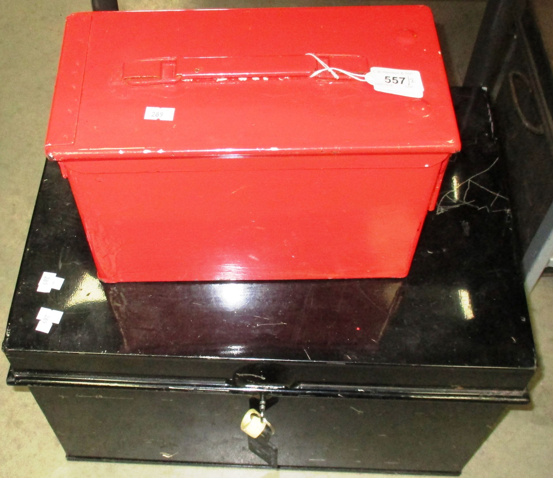 Black metal deed box with key and a red painted metal ammunition box