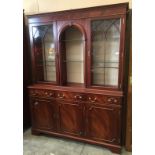 A reproduction mahogany wall unit with two glazed doors,