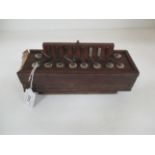 A small accordion in dark wood case
