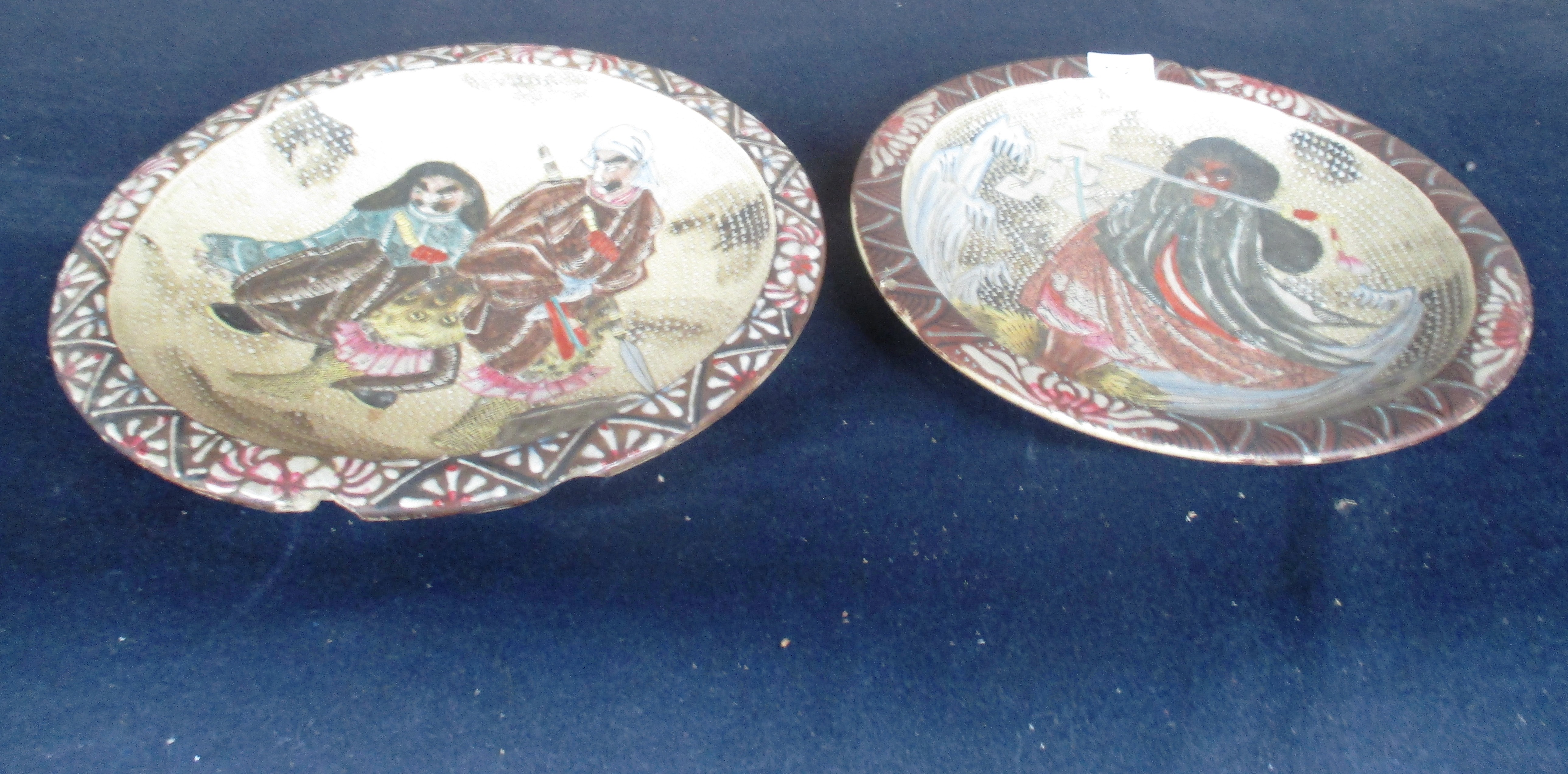 A pair of Japanese satsuma style circular pottery wall plates,