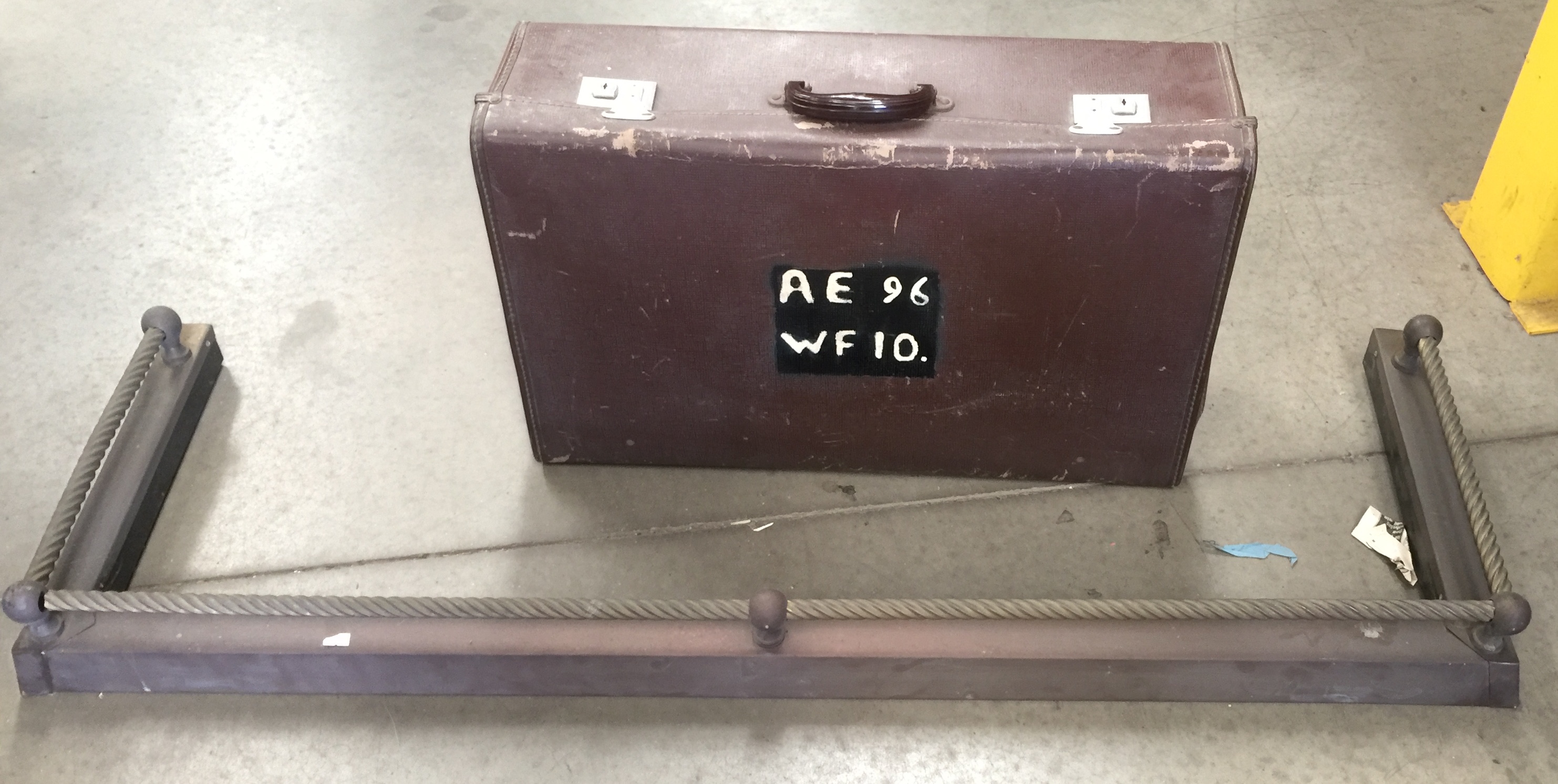 2 x items - a brass fire fender and a suitcase
