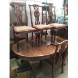 Oak oval extending dining table with winding handle, complete with two additional leaves,