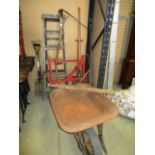 Contents to corner - wheel barrow, wooden step ladders, scythe,