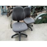 Two grey upholstered operators swivel chairs