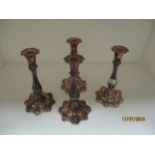 A set of four silver plated candle sticks