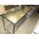 A stainless steel two shelf preparation table 60 x 180cm