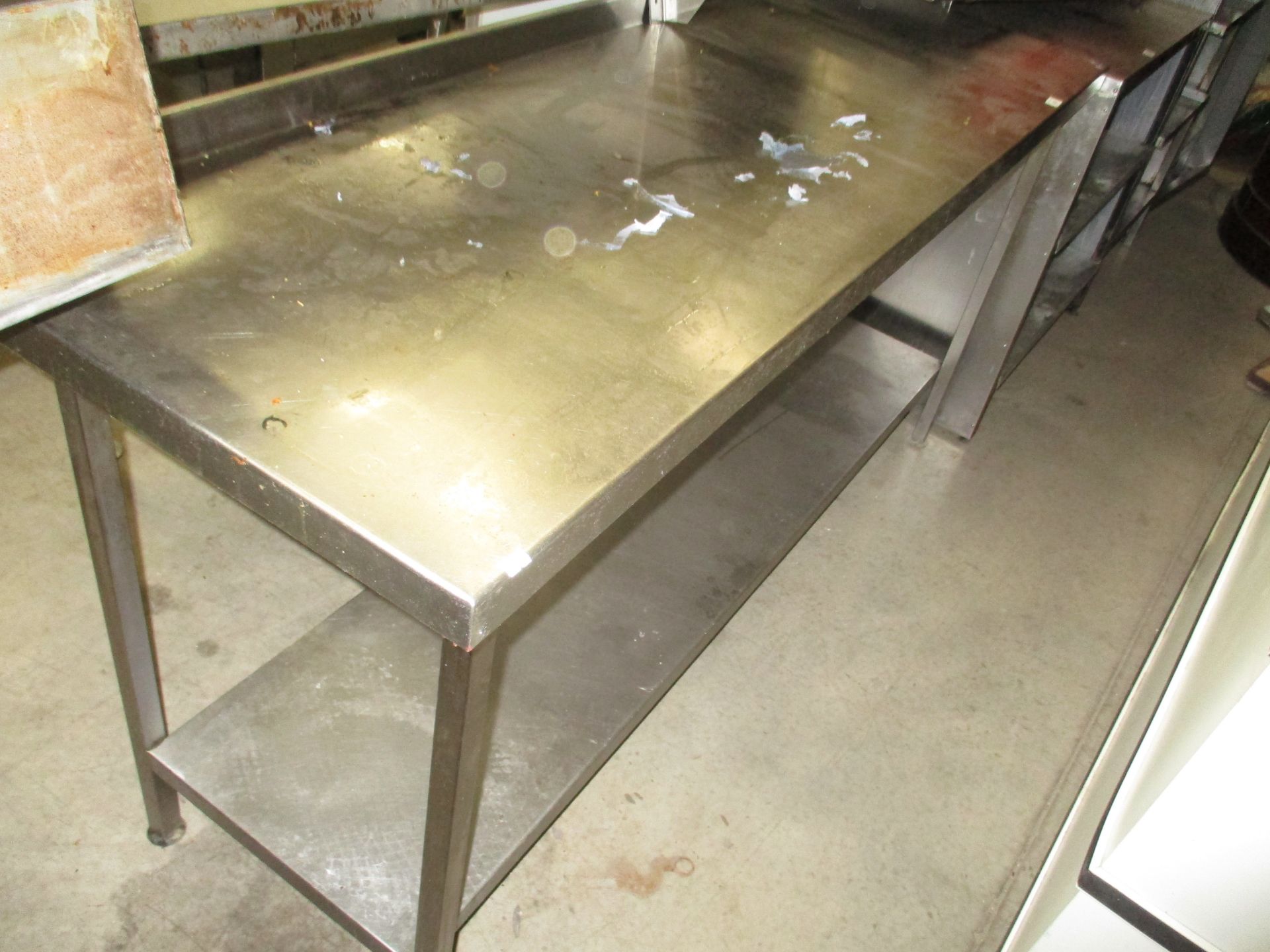 A stainless steel two shelf preparation table 60 x 180cm