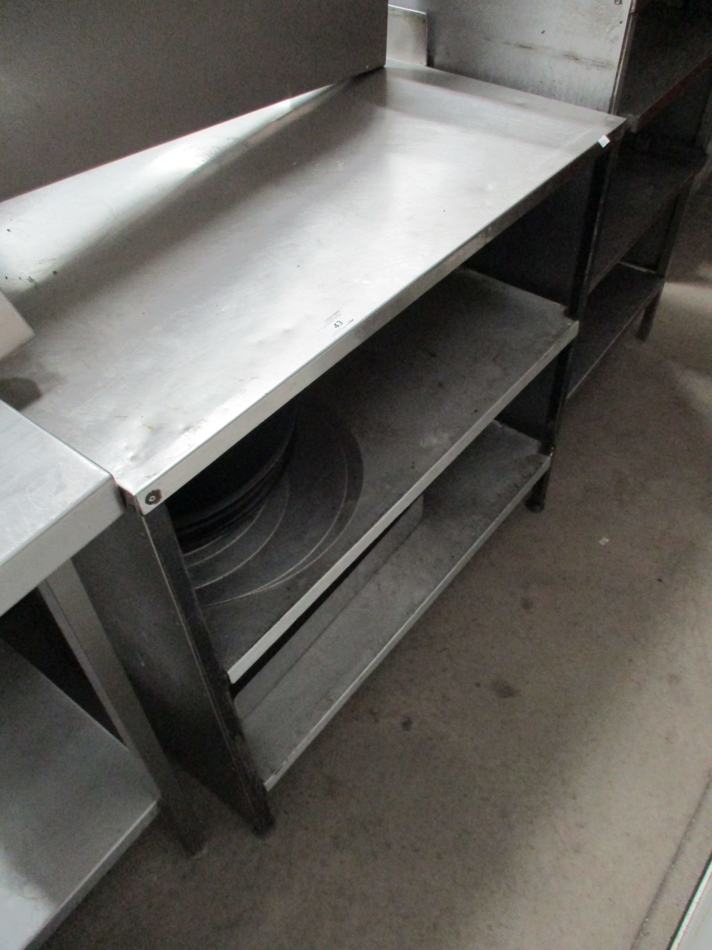 A stainless steel three shelf preparation table 60 x 90cm complete with a quantity of baking trays