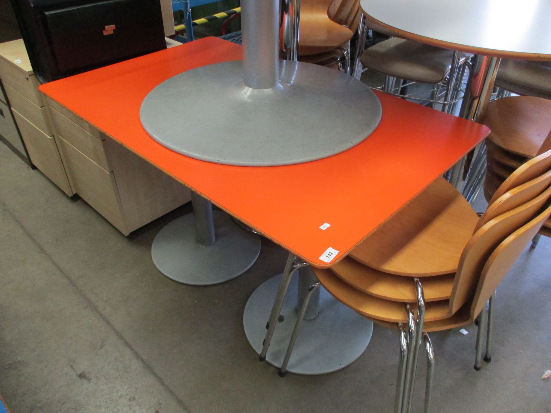 An orange wooden cafe table 74 x 120cm on two colum bases