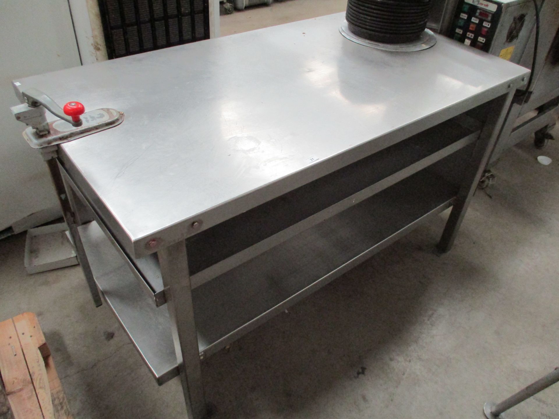 A stainless steel preparation table with under shelf and a manual can opener