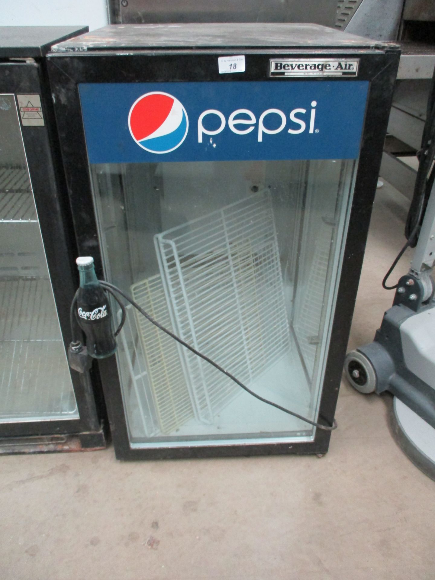 A Beverage Air single door glass front Pepsi bottle chiller