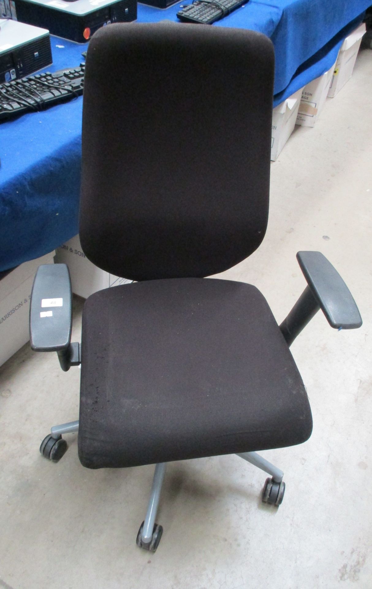 A black upholstered operators swivel armchair