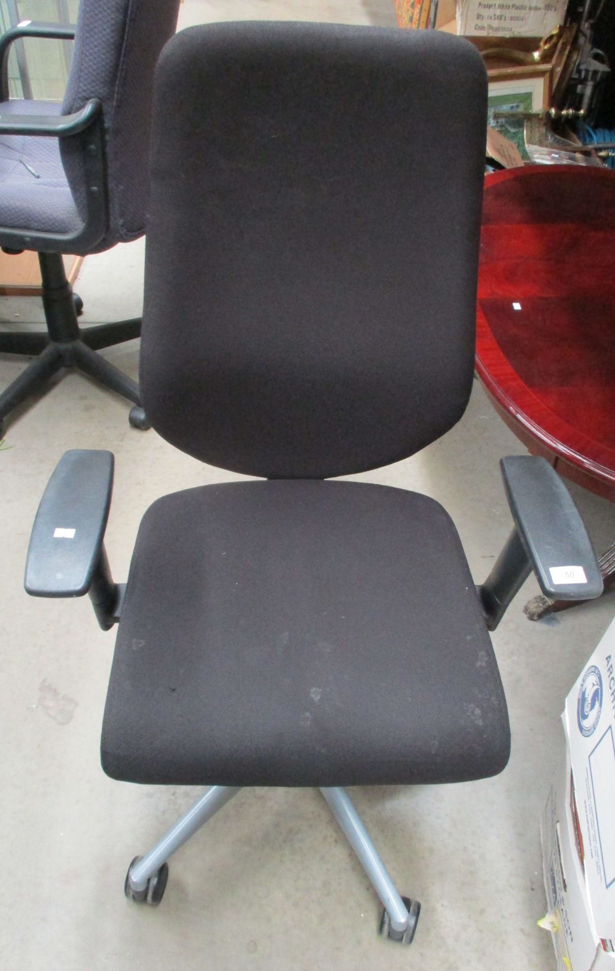 A black upholstered operators swivel armchair