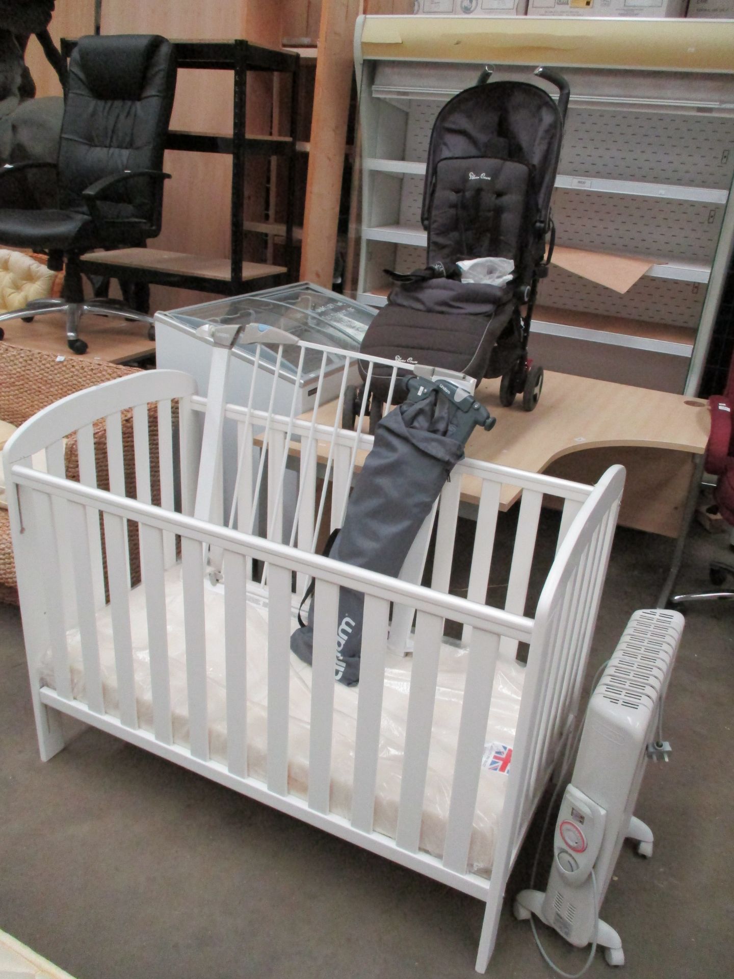 A white wooden cot with a mattress complete with a Lindam safety gate and Silver Cross pushchair