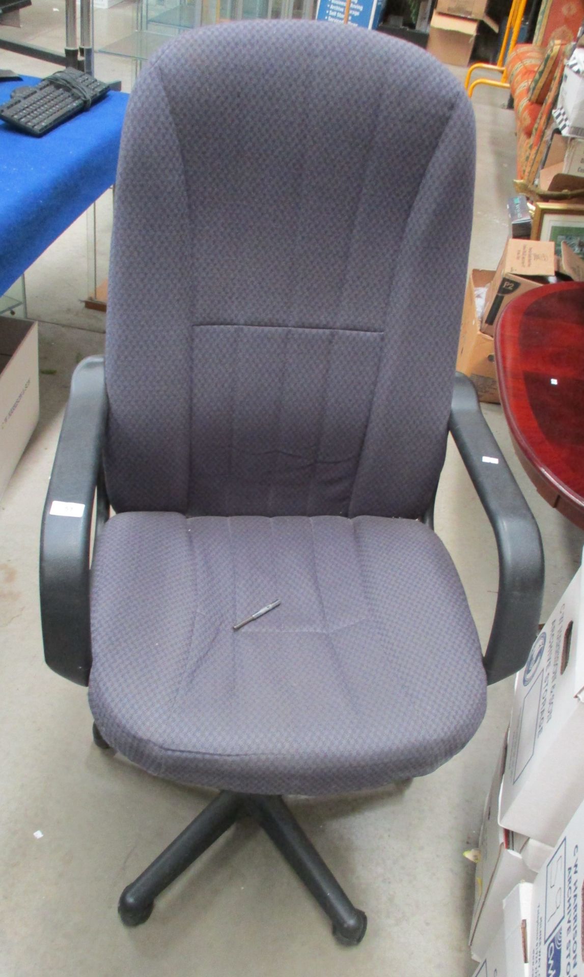 A purple patterned upholstered high back operators swivel armchair
