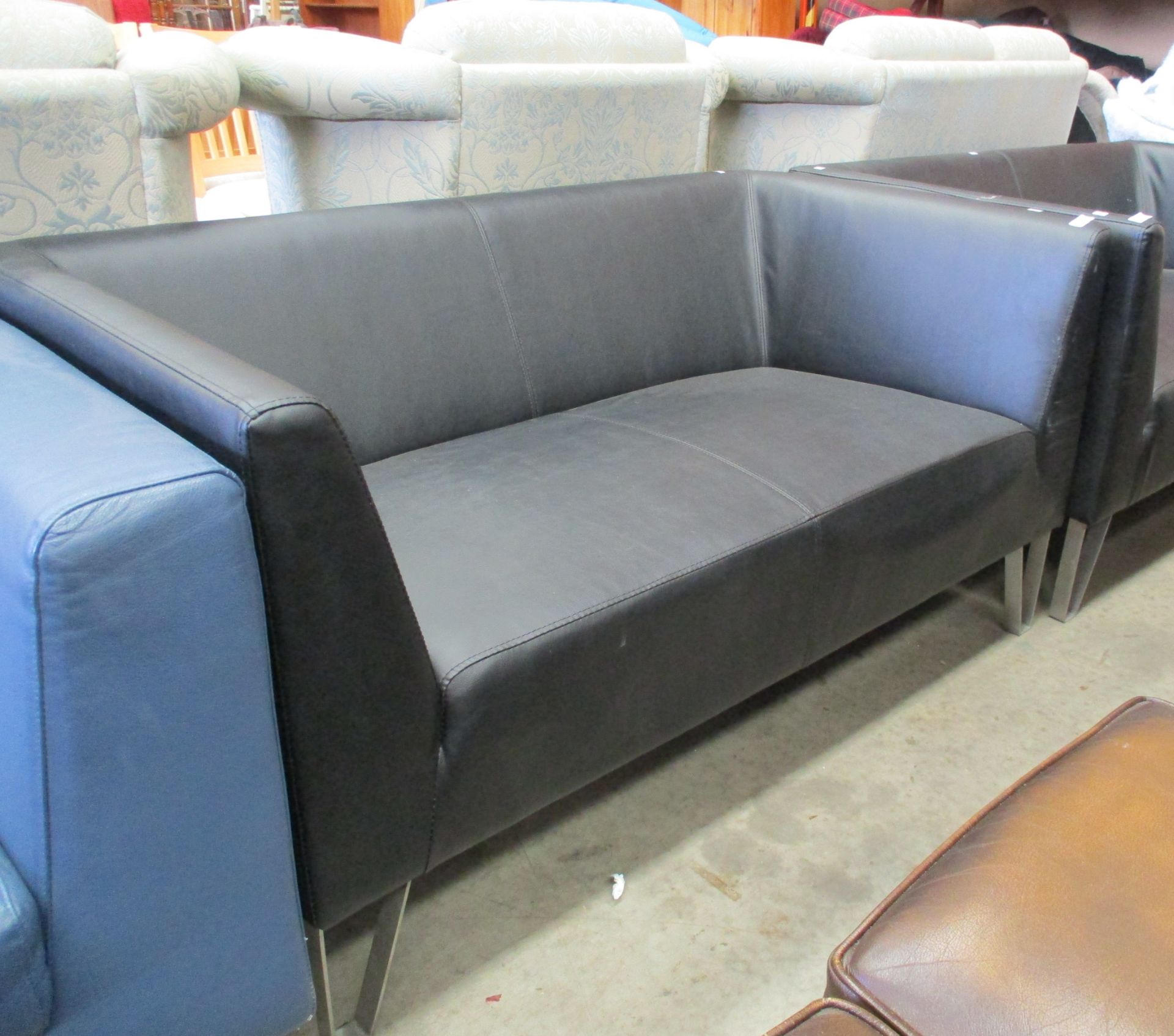 A black vinyl two seater settee