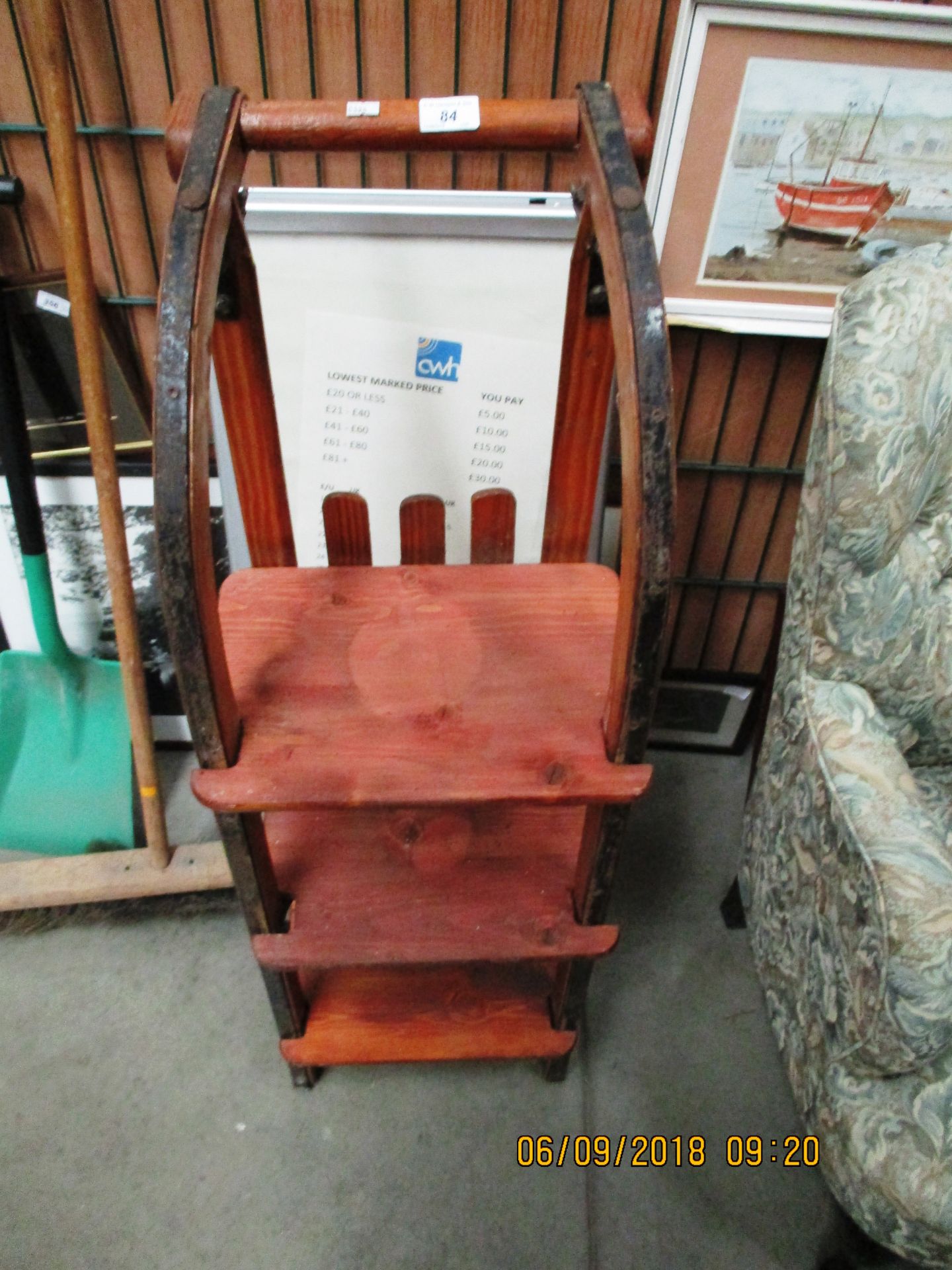 A vintage wooden sledge which converts into a three shelf bookcase