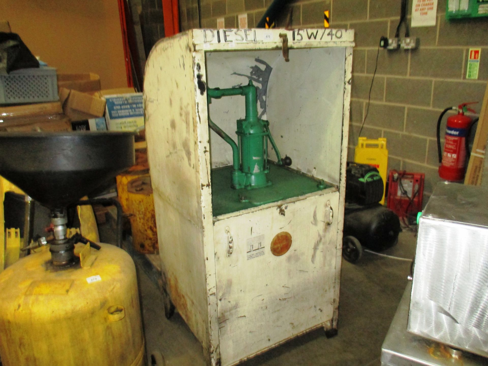 Freestanding manual diesel pump in white metal case,