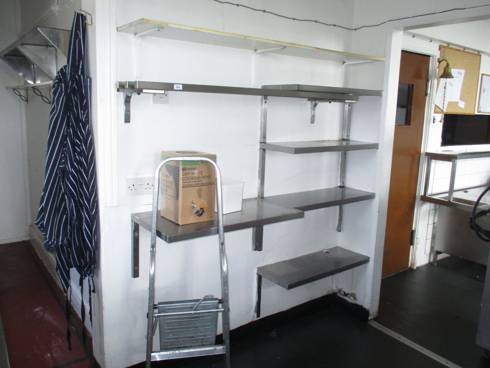 A quantity of wall mounted stainless steel shelving together with a small aluminium stepladder