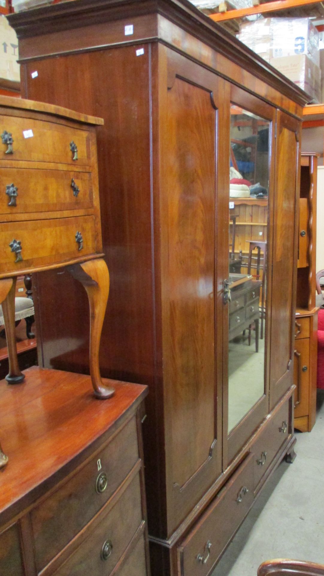 A walnut single mirror door wardrobe with two underdrawers,