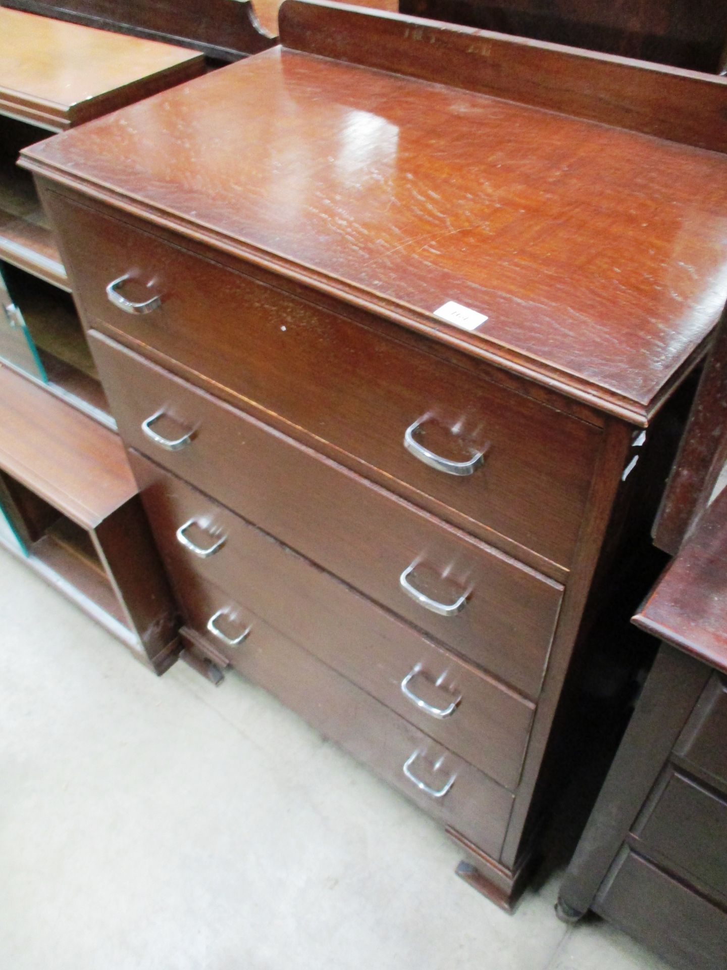 A dark stained oak four drawer chest of drawers