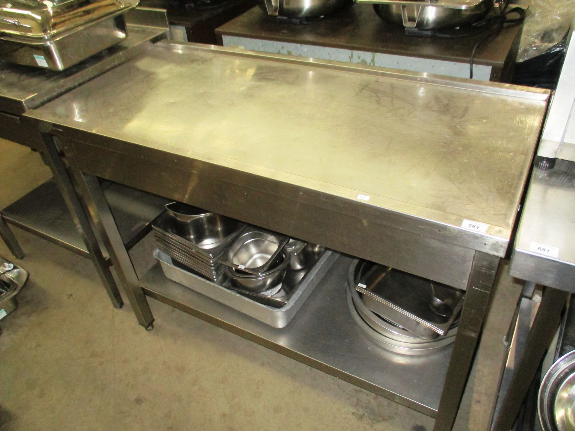 A stainless steel preparation table with undershelf,