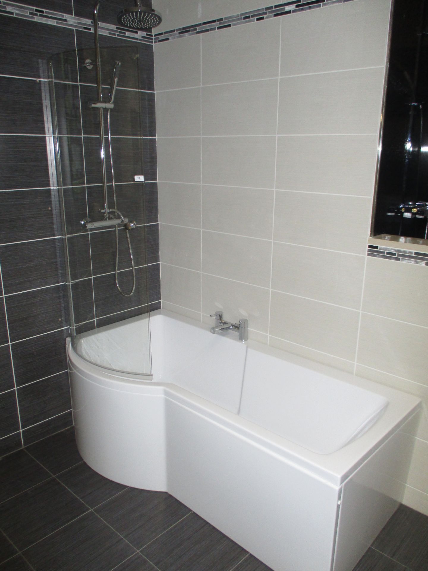 Left hand curved bath with side panels,