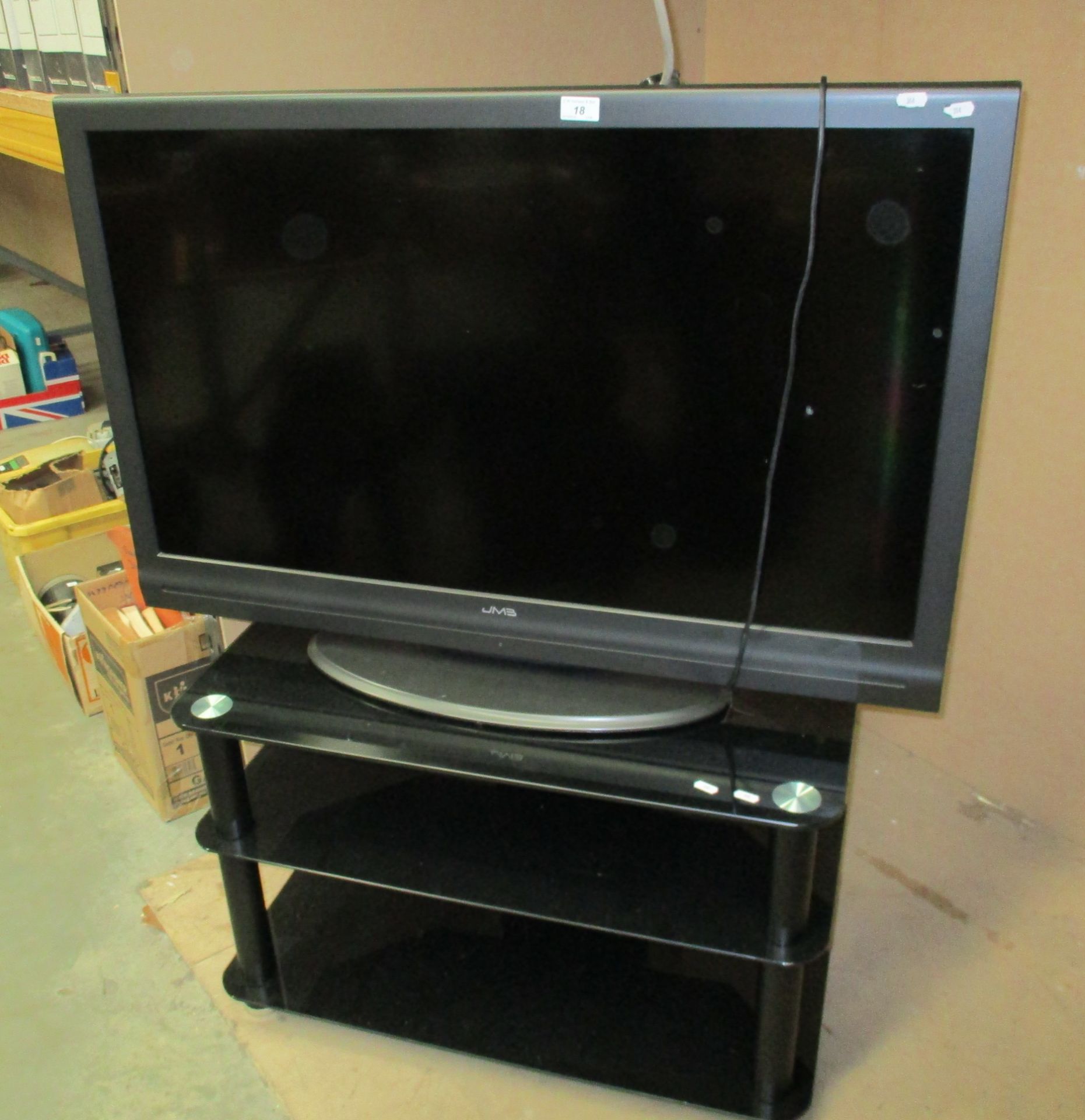 A JM3 model 42883 42" Full HD LCD TV - no remote control complete with a smoked glass 3 tier TV