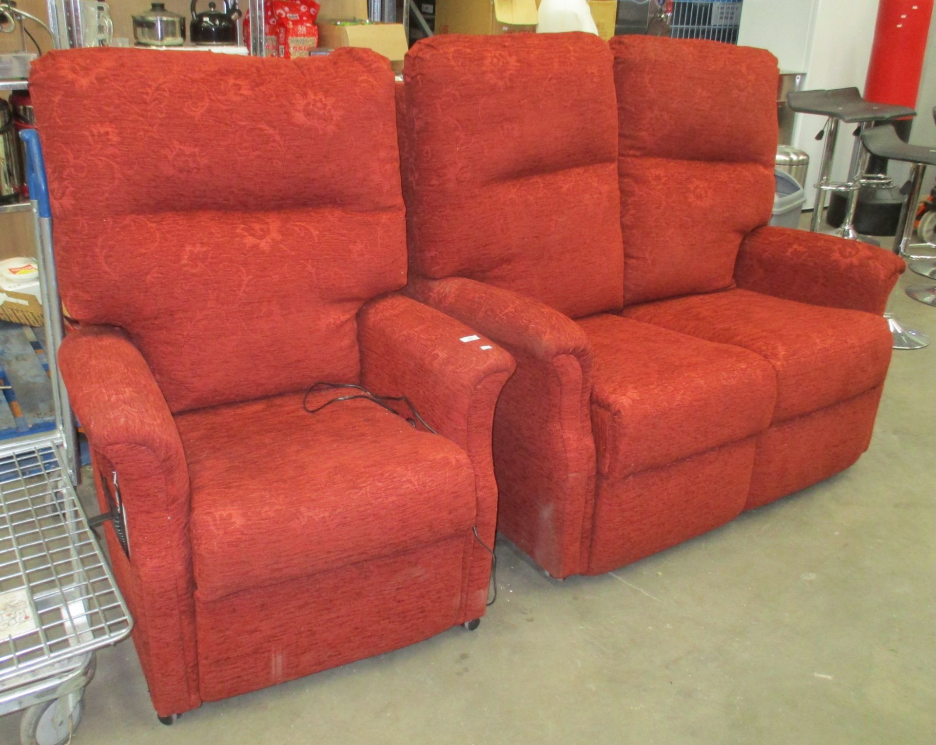 A burnt orange upholstered high back two piece suite comprising two seater settee and an