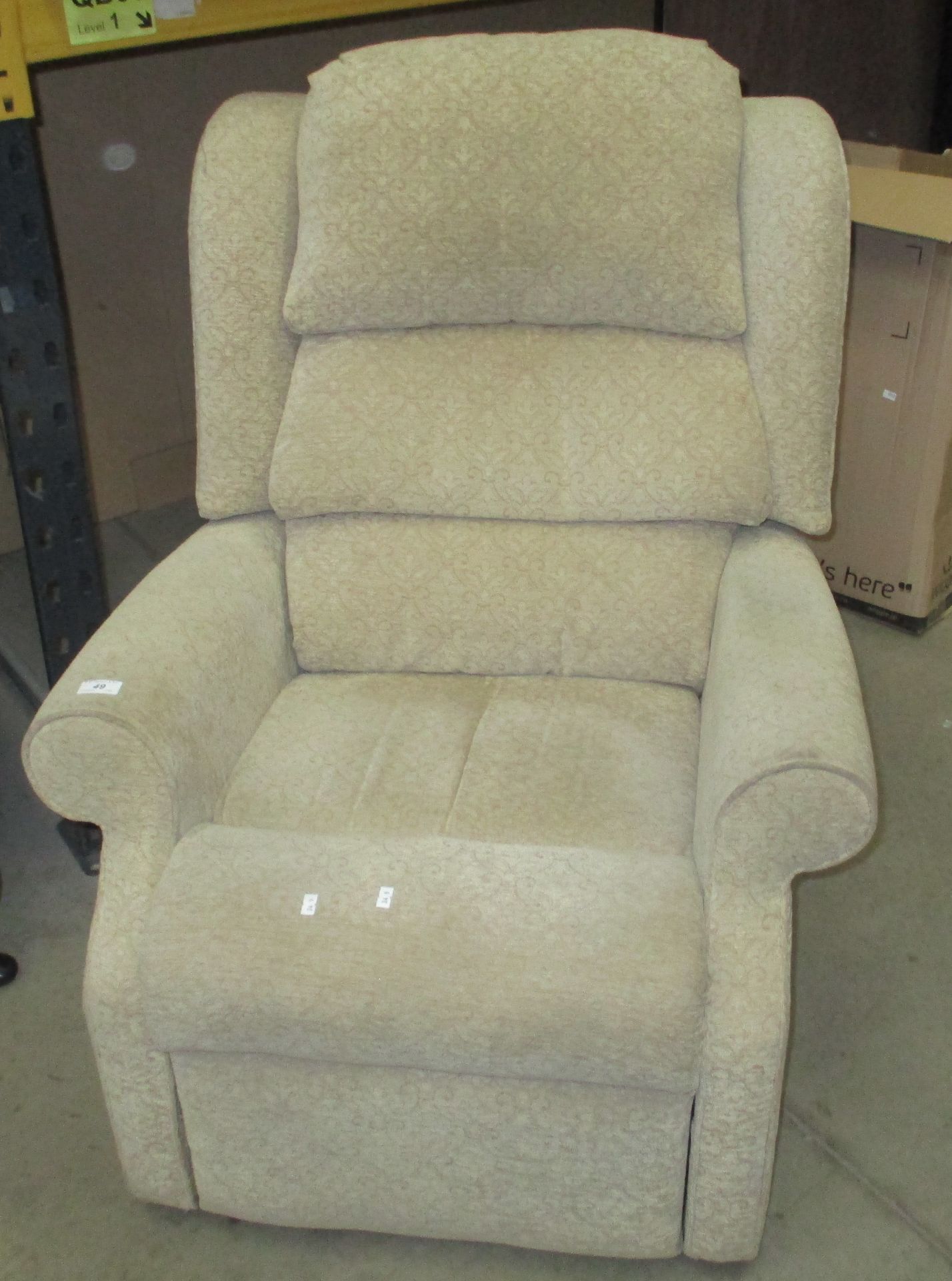 A light brown upholstered reclining armchair
