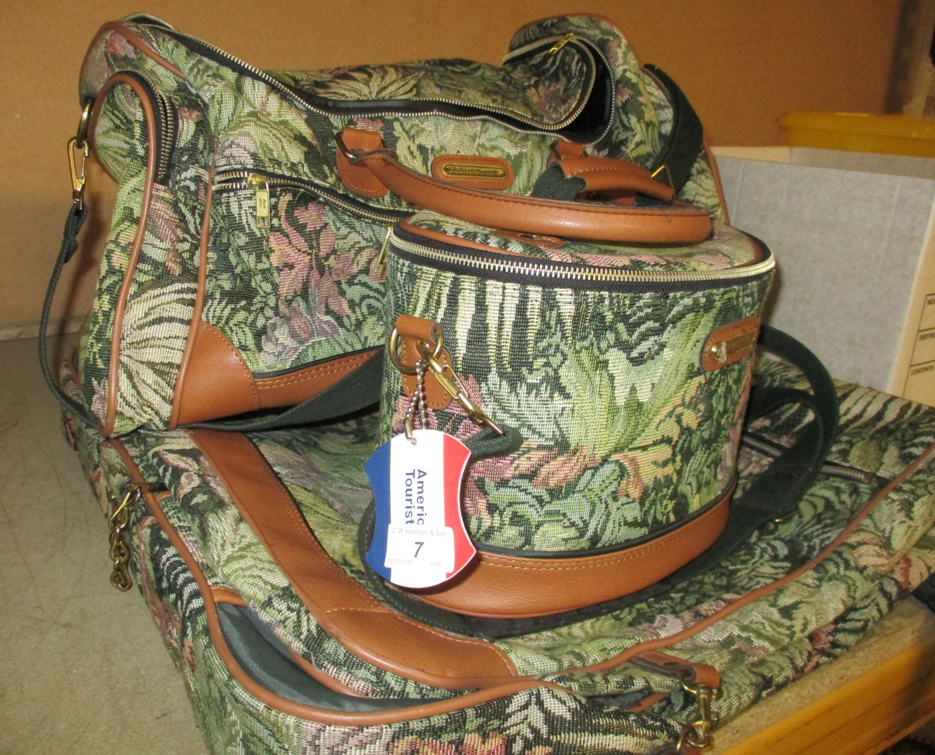 An American Tourister patterned 3 piece travel set