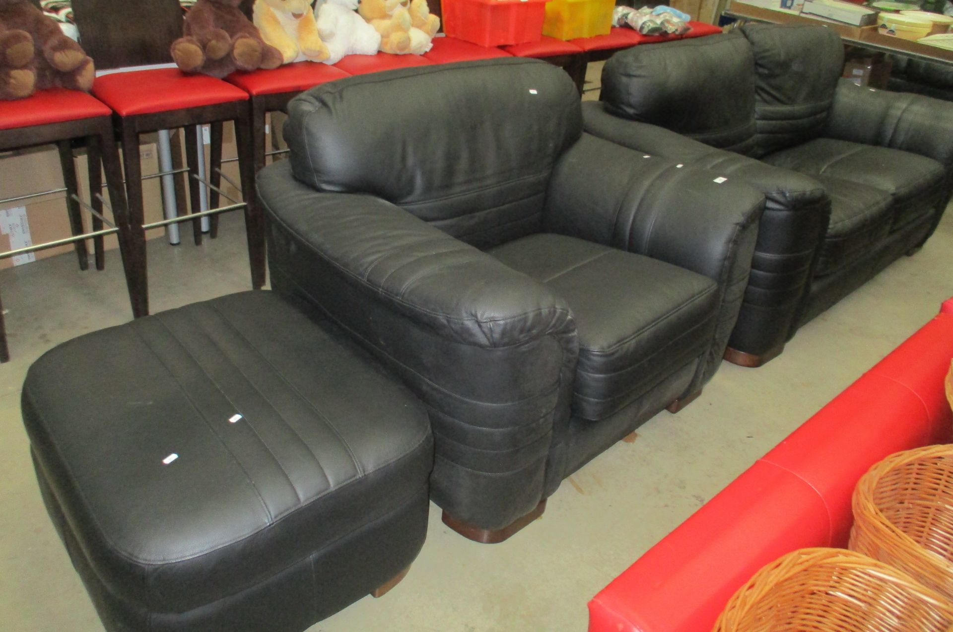 A black leather three piece suite comprising two seater settee,