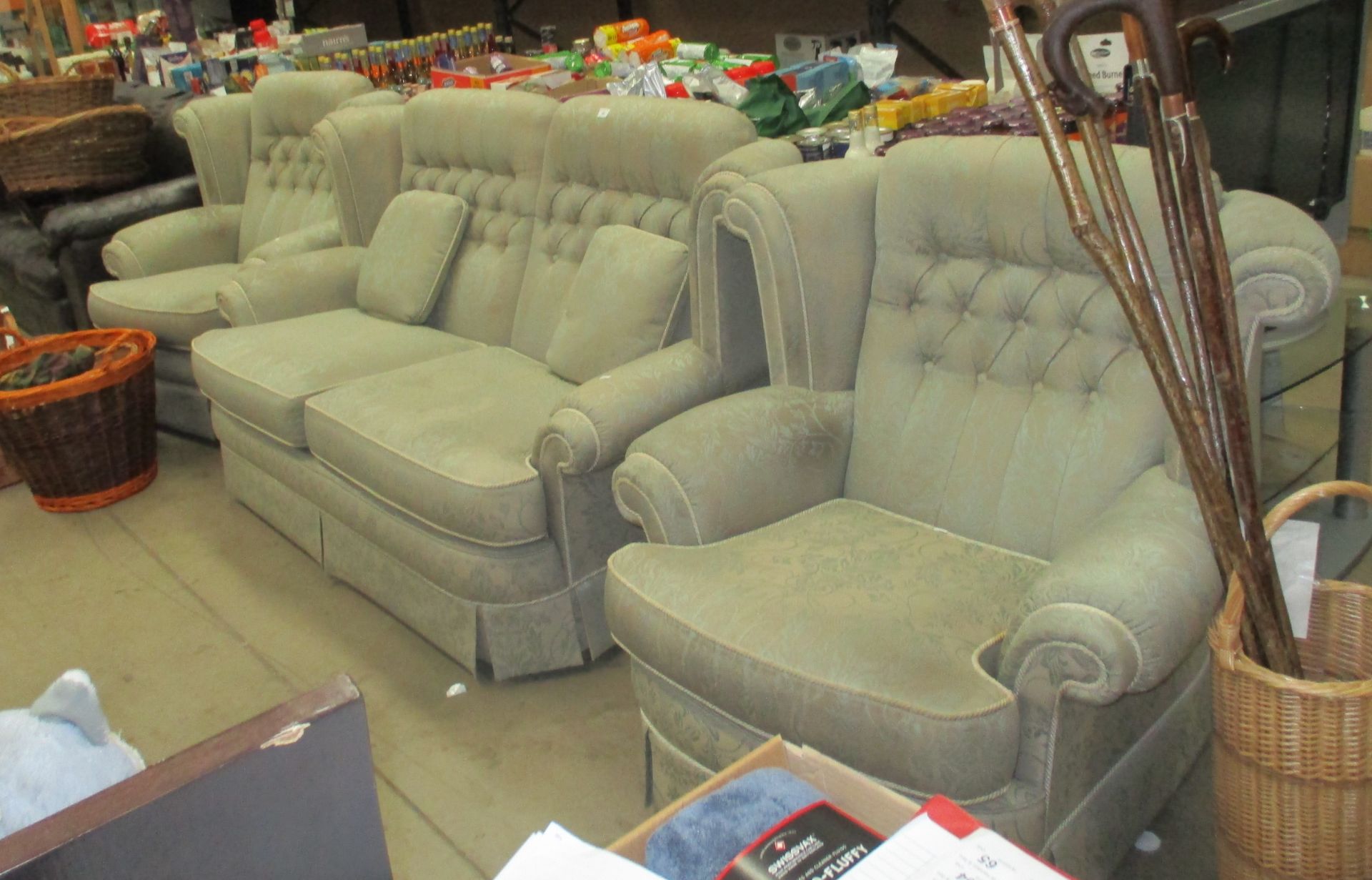 A light green patterned deep buttoned back three piece suite comprising a three seater settee and