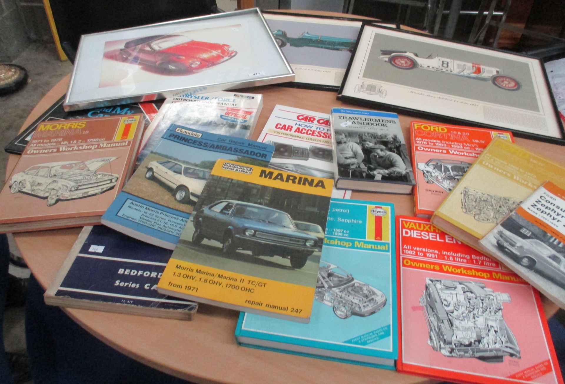 Various vehicle and other workshop manuals and three prints of iconic cars
