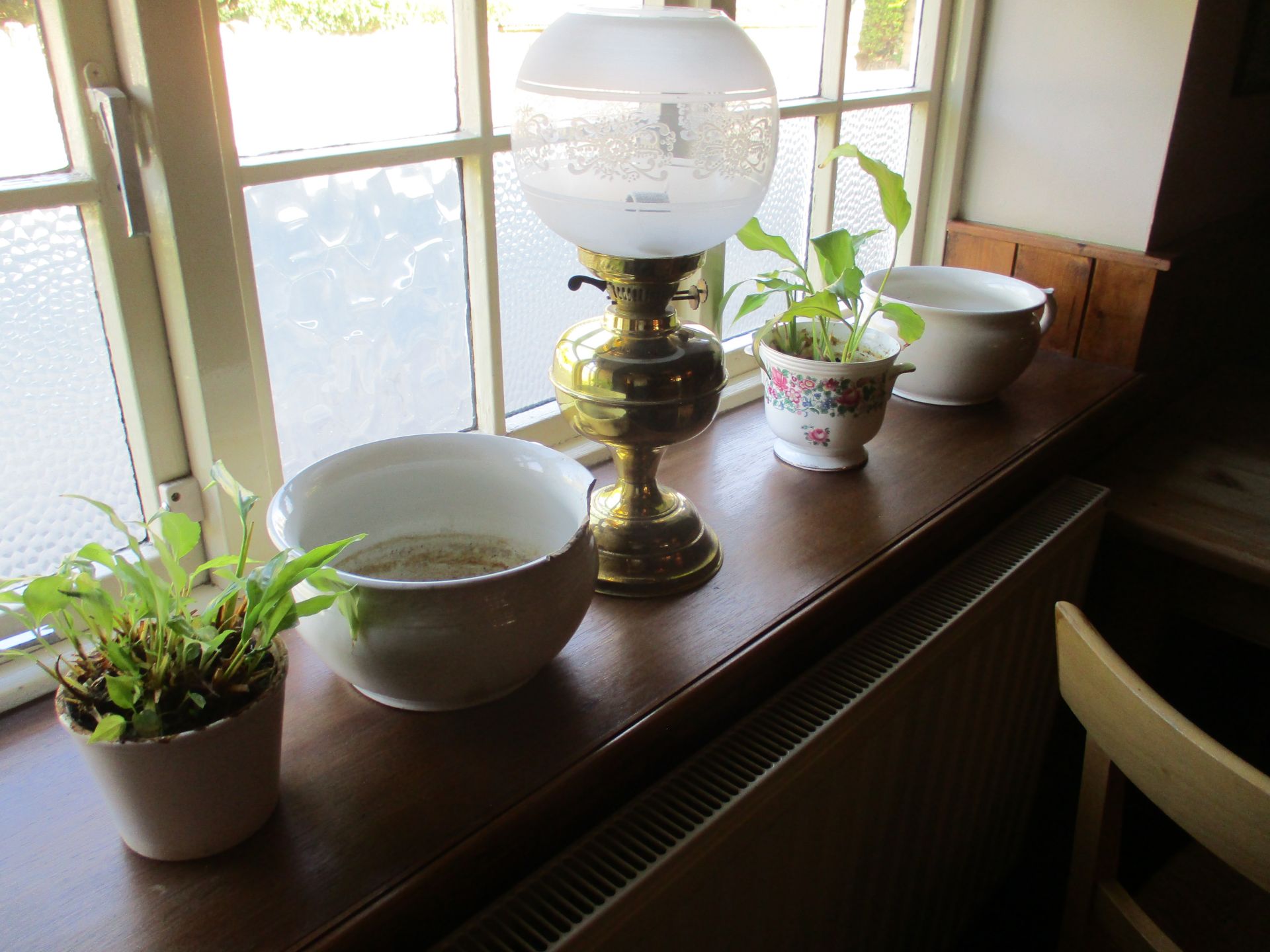 Contents to window ledge - brass oil lamp with glass shade,