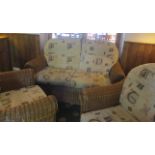 Three piece wicker conservatory suite comprising two seater sofa and two armchairs - including six