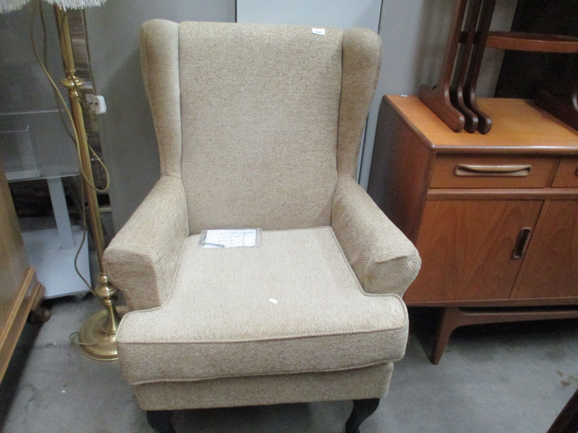 An oatmeal upholstered Paris wingback armchair