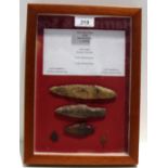 A framed display of Neolithic flint tools including stone age knife,