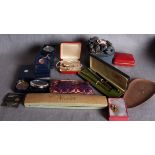 A box and a plastic basket containing an assortment of costume jewellery and dressing table