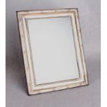 A rectangular picture frame with ribbon tied and reeded border, strut support,