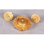 A Victorian gold memorial brooch of flower head form, centred by a diamond,